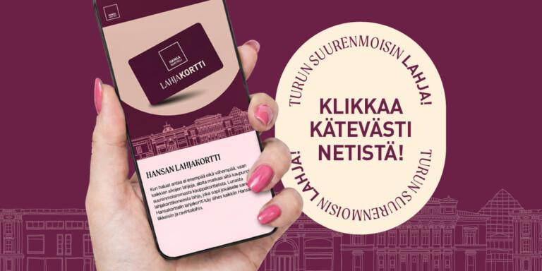 Käsi pitelee älypuhelinta, jossa näkyy lahjakortti ja kehotus Klikkaa kätevästi netistä.